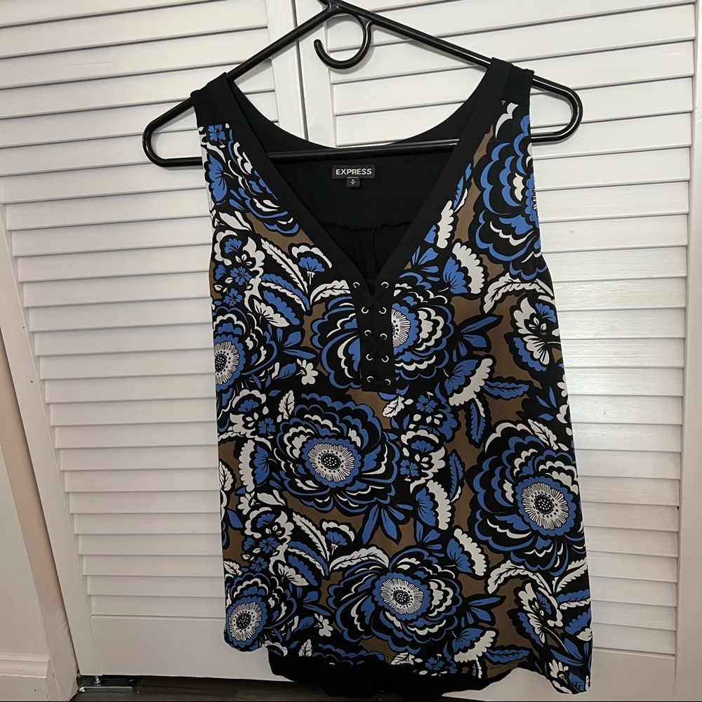 Medium sleeveless blouse with criss cross design on front and floral design